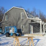 Exterior view of galvanized steel barndominiums in Todd Creek, Colorado, showcasing modern design and rural charm