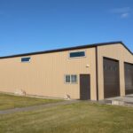 Exterior view of galvanized steel shops in Mansfield, Texas showcasing modern architectural design and durable materials