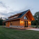 Modern prefab barndominium homes blending rustic charm and contemporary design in a picturesque rural landscape.